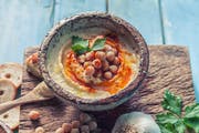 Hummus with tahini. Tahini is a condiment made from toasted ground hulled sesame seeds.