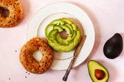 Delicious bagel toast with avocado slices. Healthy breakfast, top view